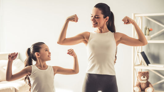 mom and daughter showing their muscles