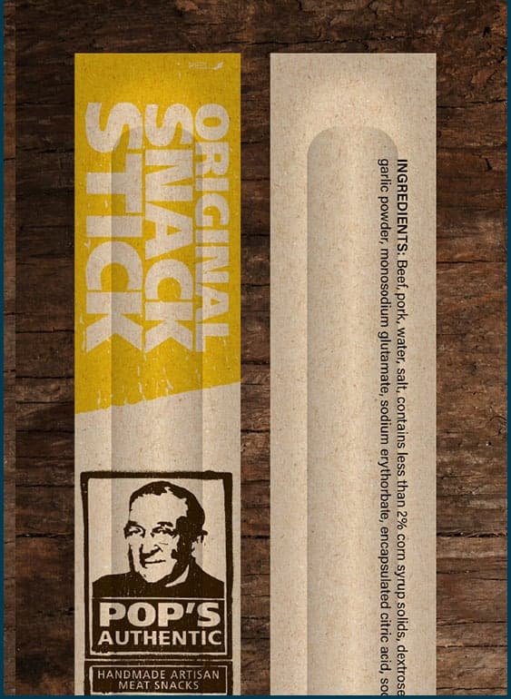 A pair of Pop’s Original Snack Sticks individually wrapped on a wooden table.